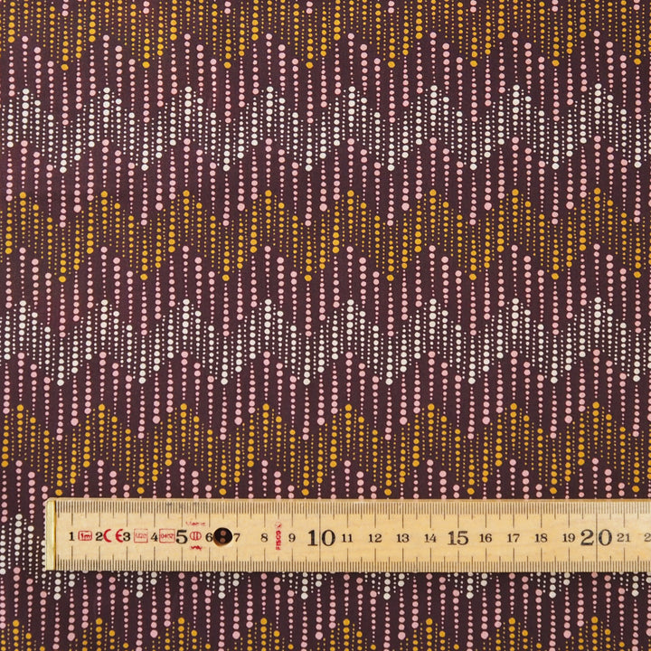 Liberty fabric with a subtle spotted chevron pattern on a plum background