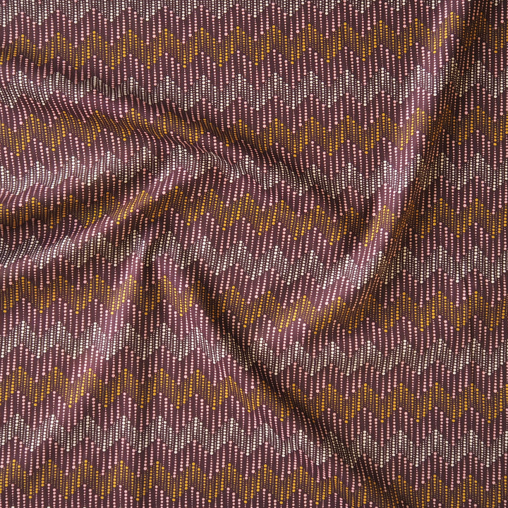 Liberty fabric with a subtle spotted chevron pattern on a plum background