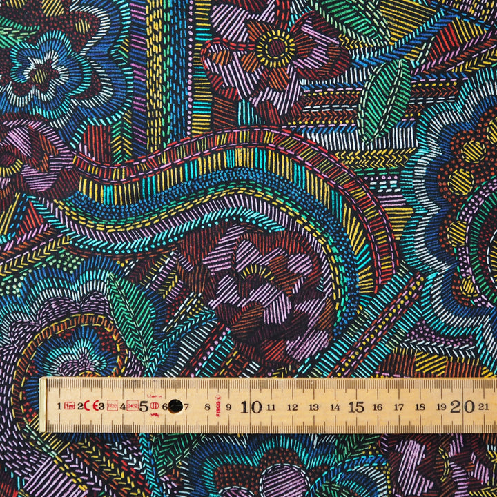 Close-up of a colorful Liberty patterned fabric with intricate designs.