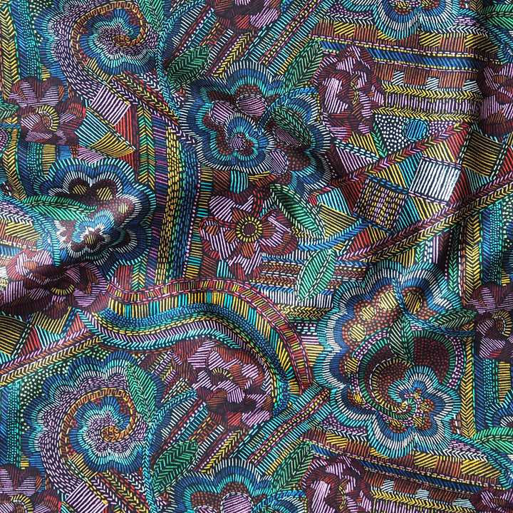 Close-up of a colorful Liberty patterned fabric with intricate designs.