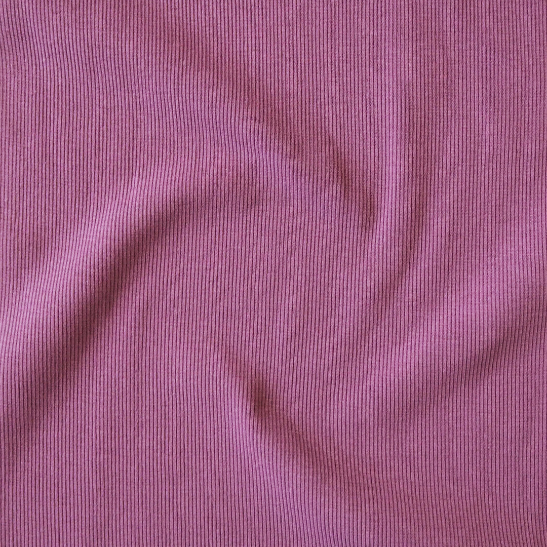 Close-up of orchid pink ribbing fabric with a ribbed texture