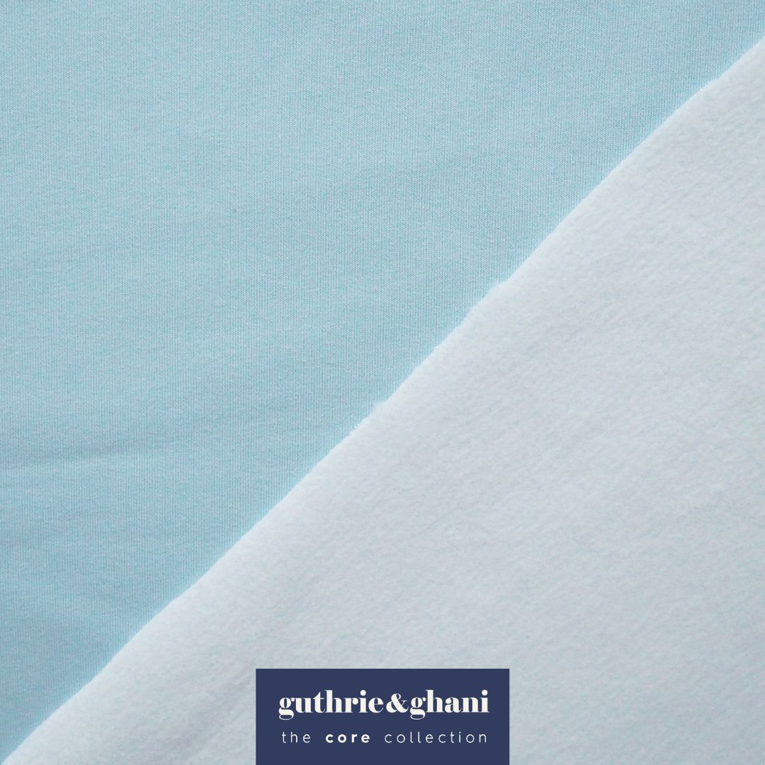 Close-up of light blue fabric with a subtle texture on a matching background