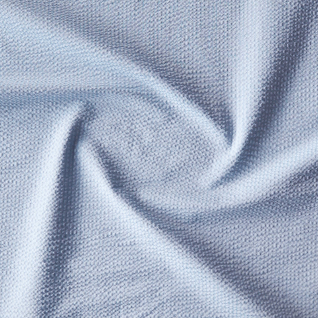 Light blue textured cotton seersucker dressmaking fabric with subtle stripes
