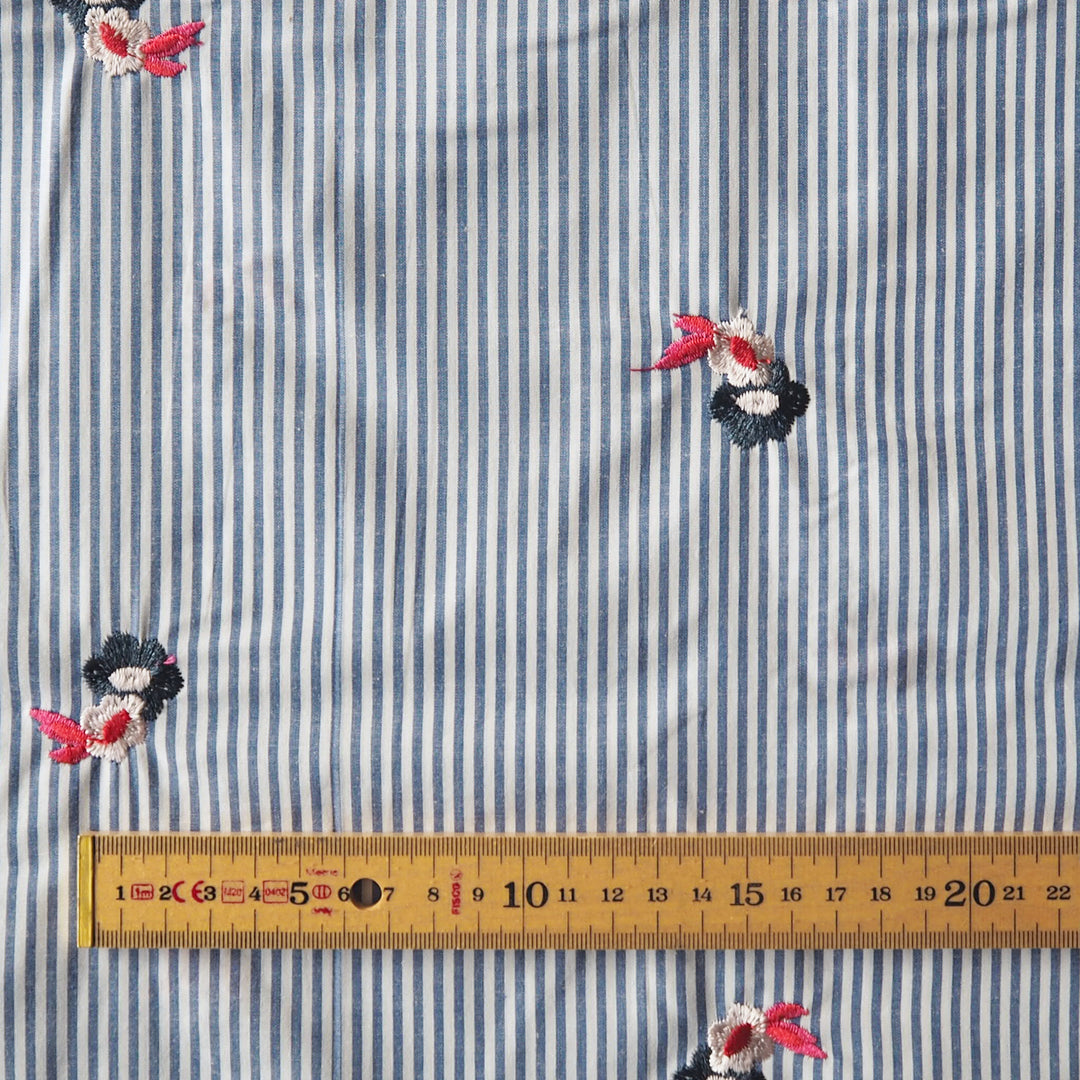 Embroidered florals on blue and white stripe cotton fabric