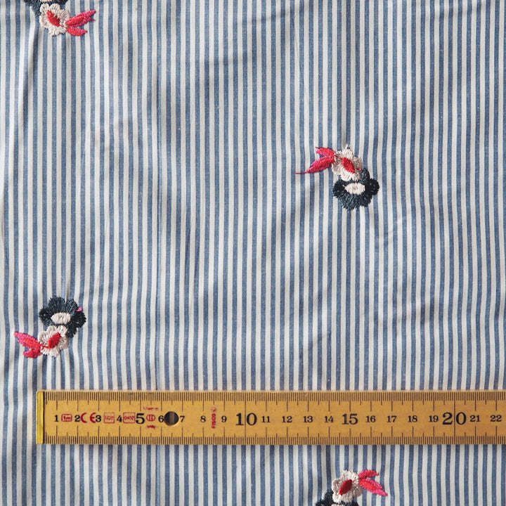Embroidered florals on blue and white stripe cotton fabric