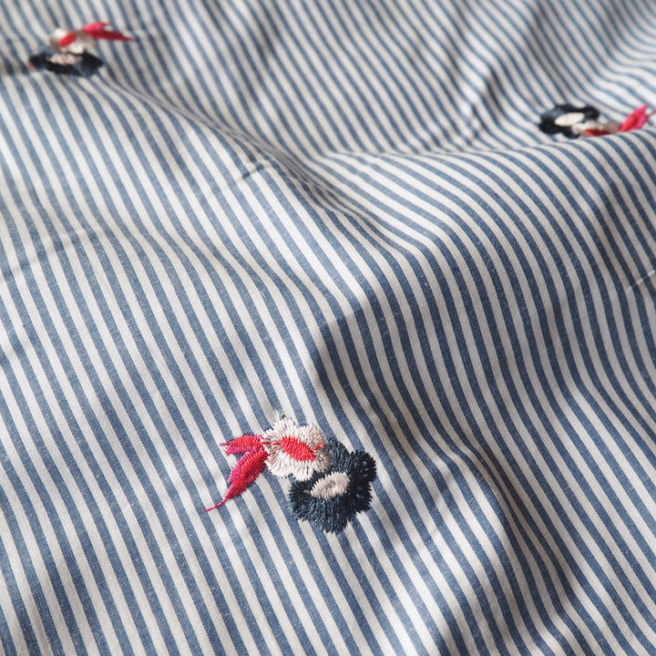 Embroidered florals on blue and white stripe cotton fabric
