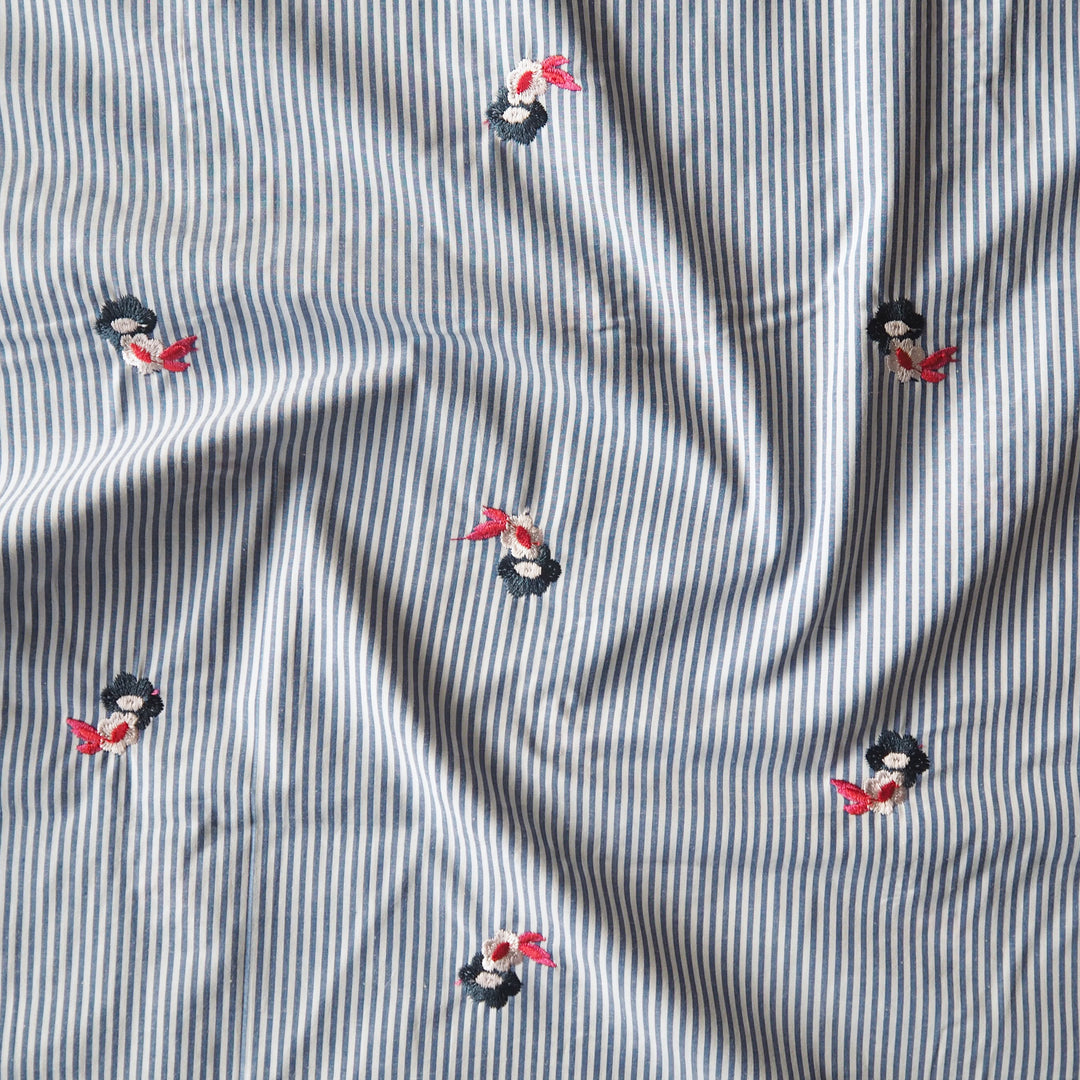 Embroidered florals on blue and white stripe cotton fabric