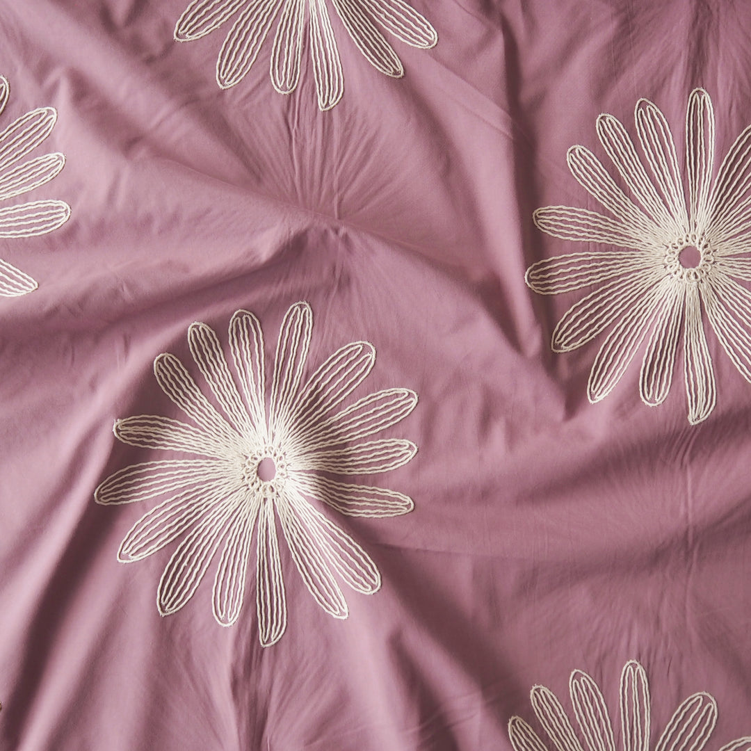 Dusky pink large scale embroidered daisy cotton dressmaking fabric
