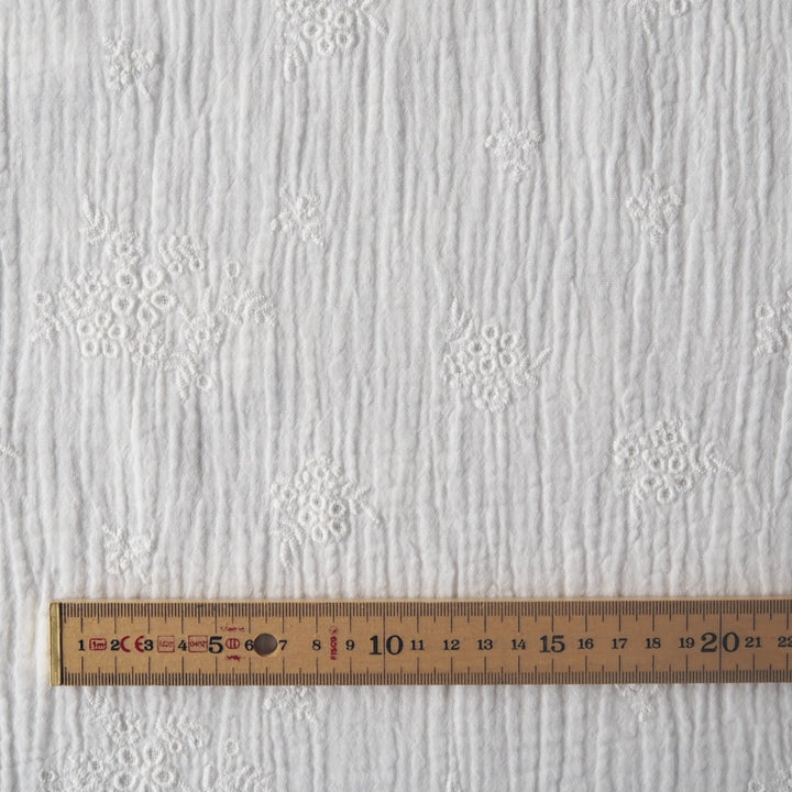 White cotton double gauze embroidered dressmaking fabric with floral embroidered pattern