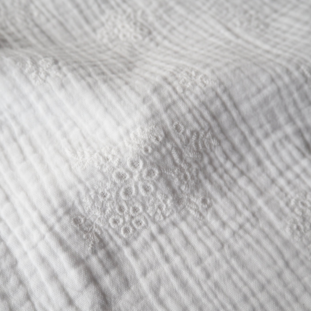 White cotton double gauze embroidered dressmaking fabric with floral embroidered pattern