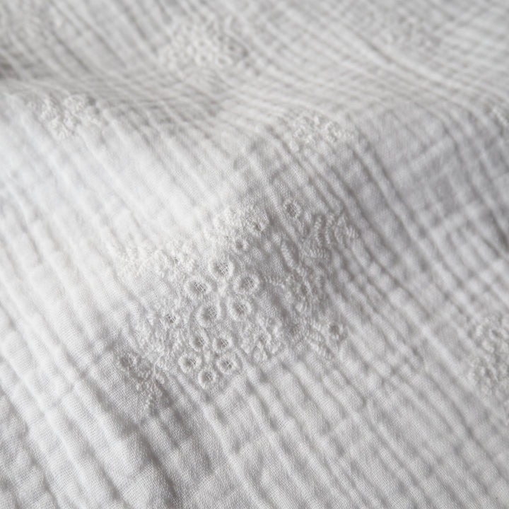 White cotton double gauze embroidered dressmaking fabric with floral embroidered pattern