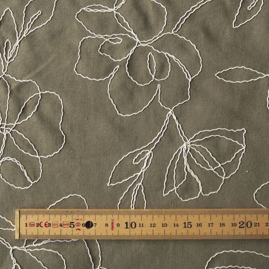 Khaki viscose linen dressmaking fabric with embroidered floral pattern