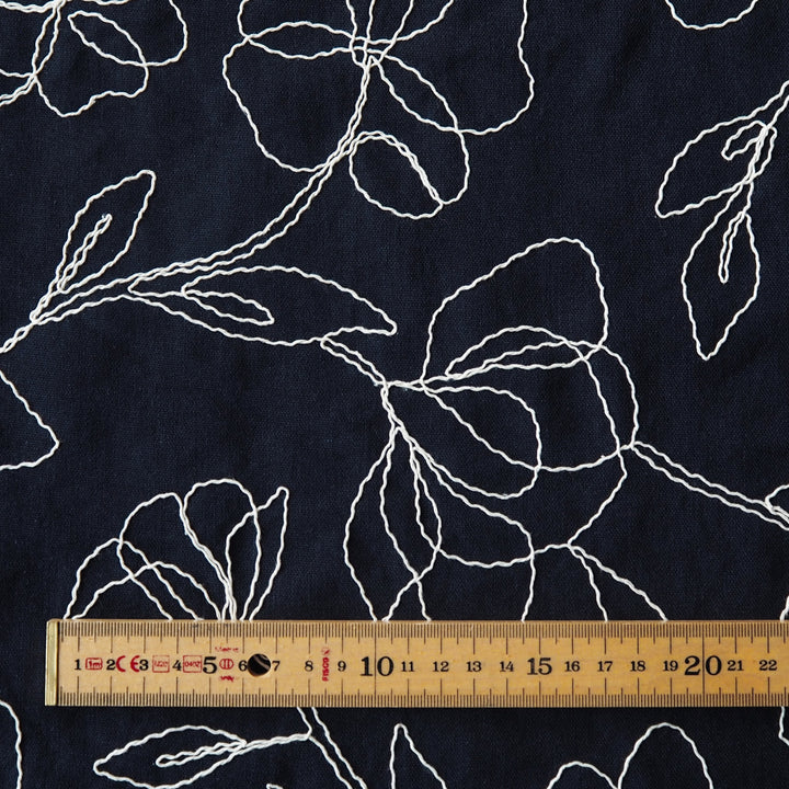 Navy viscose linen dressmaking fabric with embroidered floral pattern
