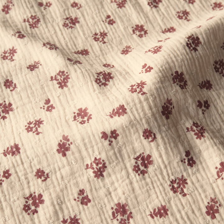 Peach cotton double gauze dressmaking fabric with dobby texture and ditsy terracotta floral pattern