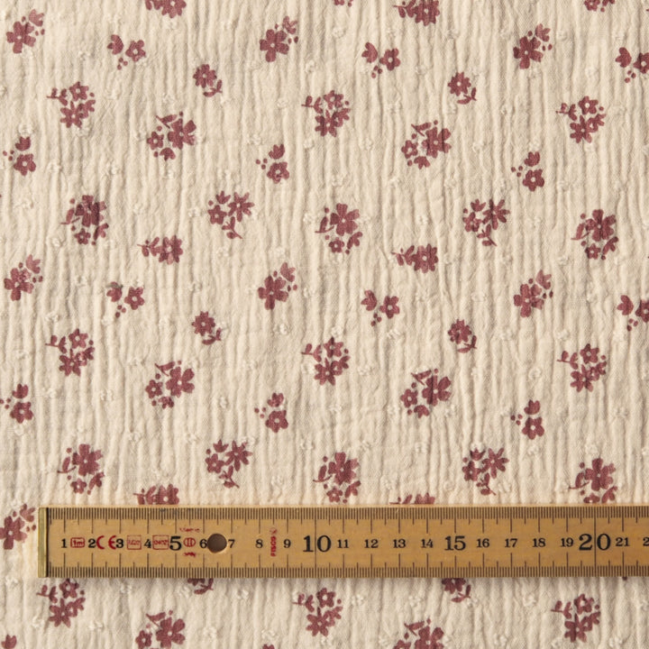 Peach cotton double gauze dressmaking fabric with dobby texture and ditsy terracotta floral pattern