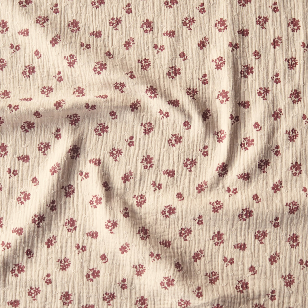 Peach cotton double gauze dressmaking fabric with dobby texture and ditsy terracotta floral pattern