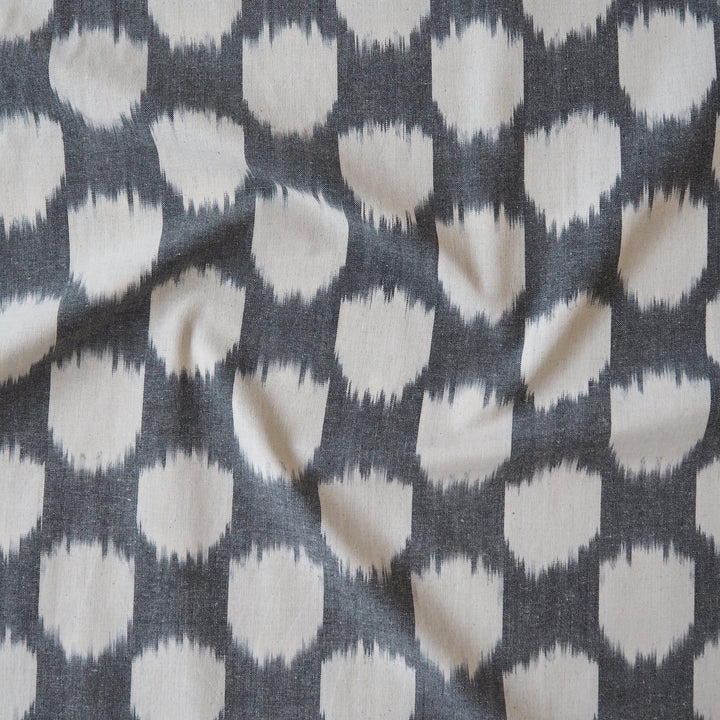 Ikat patterned dressmaking fabric in grey and white