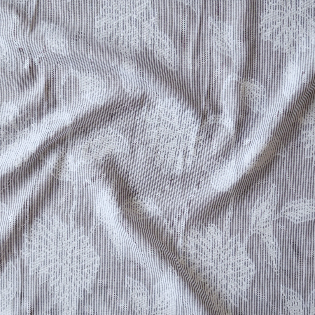 Blue striped jacquard cotton dressmaking fabric with woven floral design