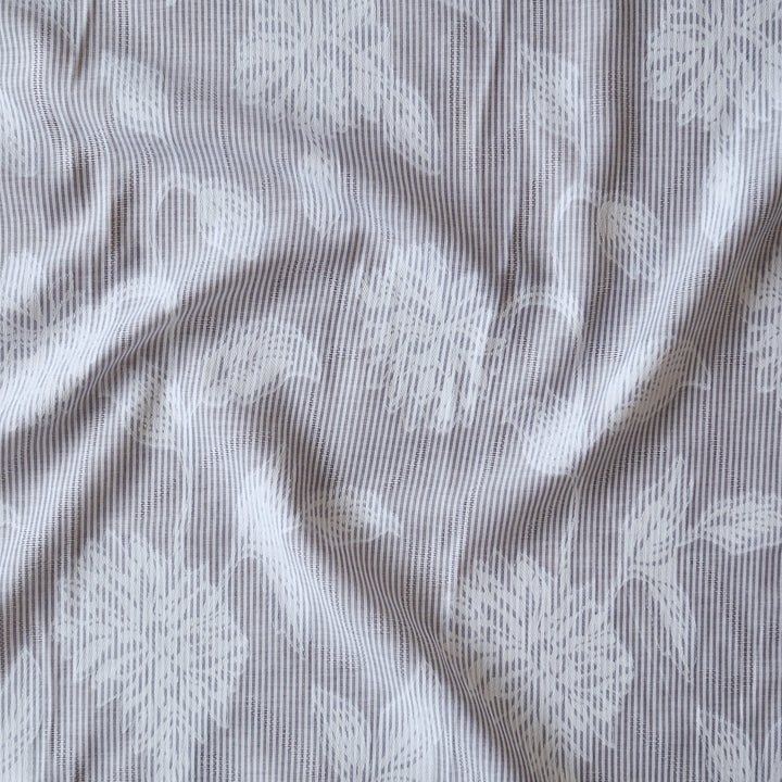 Blue striped jacquard cotton dressmaking fabric with woven floral design