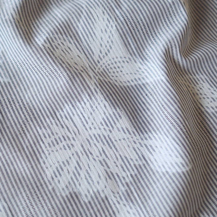 Blue striped jacquard cotton dressmaking fabric with woven floral design