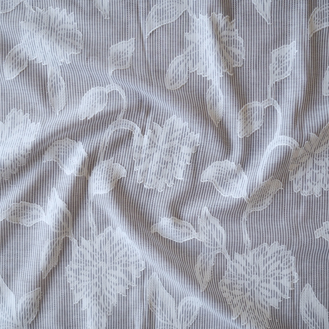 Blue striped jacquard cotton dressmaking fabric with woven floral design