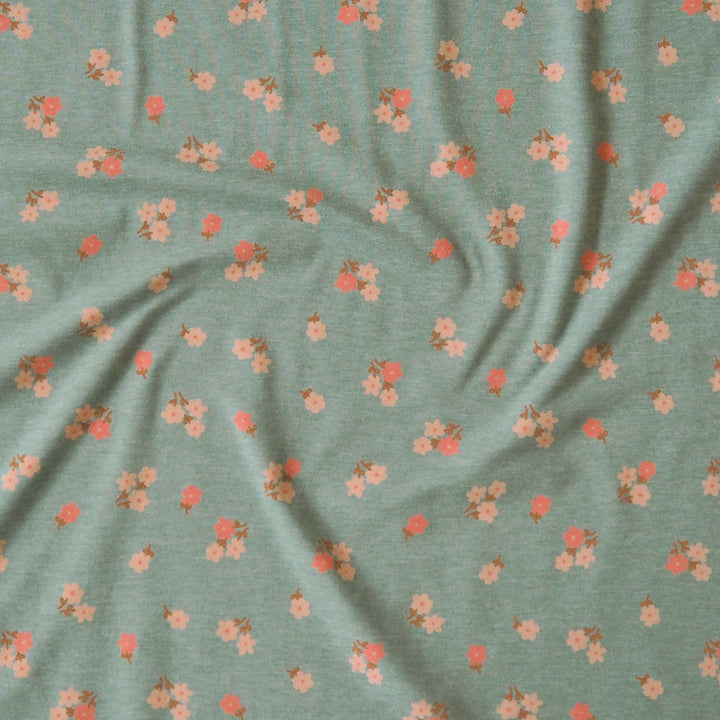 Sage melange stretch jersey dressmaking fabric with little blossom floral pattern