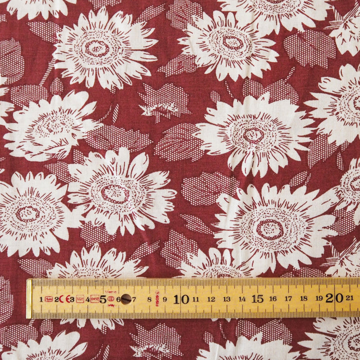 Floral patterned viscose fabric with white flowers on a red background