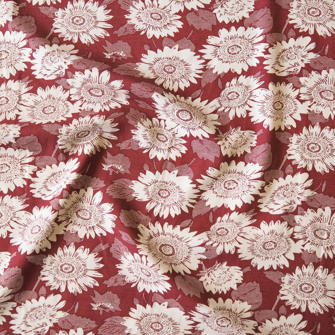 Floral patterned viscose fabric with white flowers on a red background