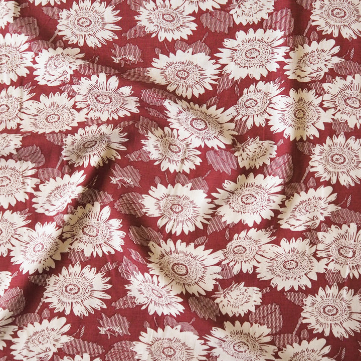 Floral patterned viscose fabric with white flowers on a red background
