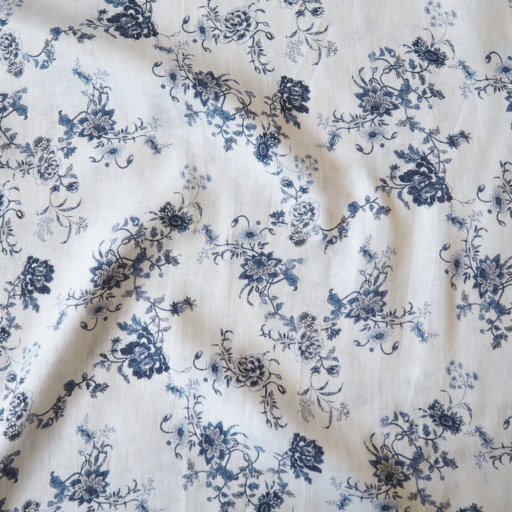 White linen fabric with blue floral pattern