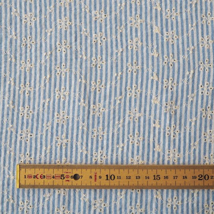 Cotton dressmaking fabric with blue and white design and floral embroidery