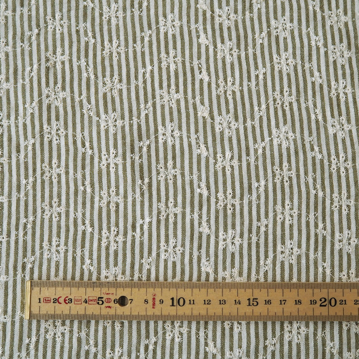 Cotton dressmaking fabric with green and white design and floral embroidery