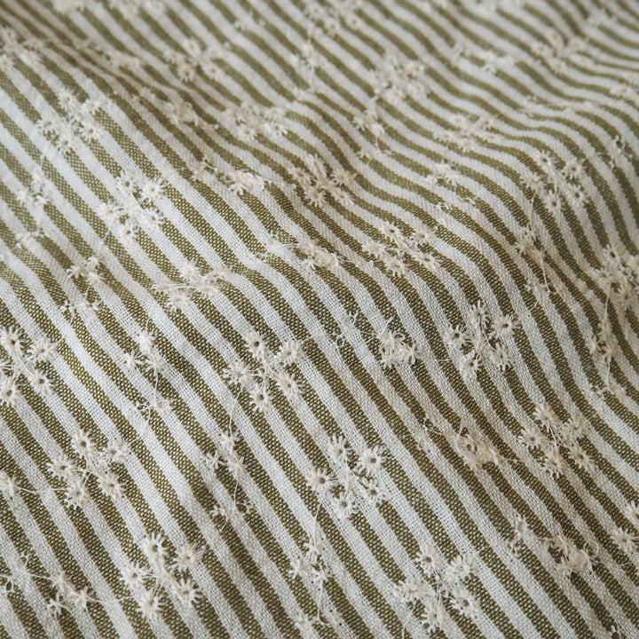 Cotton dressmaking fabric with green and white design and floral embroidery