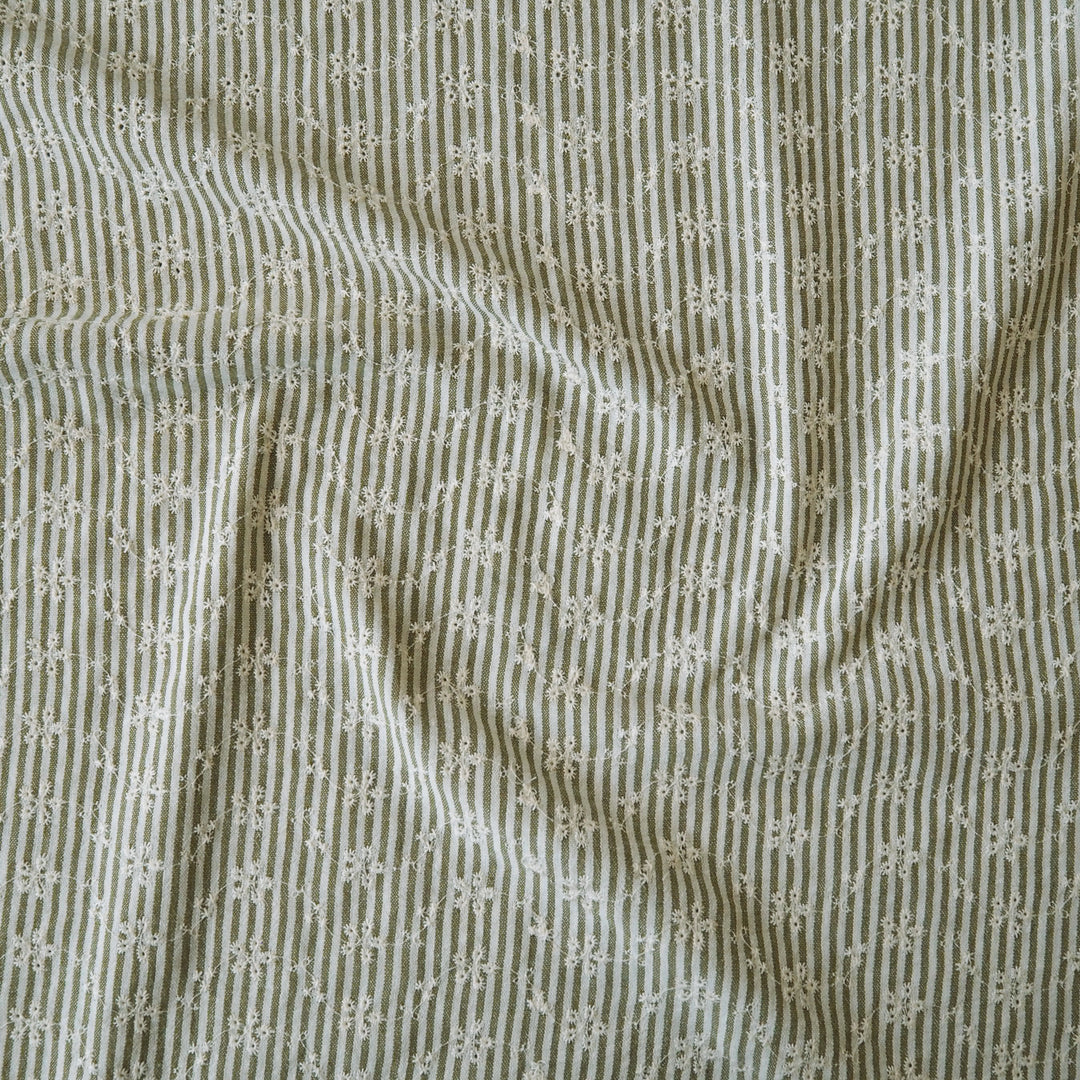 Cotton dressmaking fabric with green and white design and floral embroidery