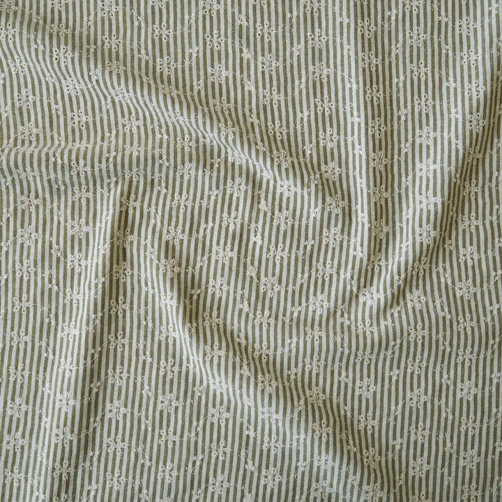 Cotton dressmaking fabric with green and white design and floral embroidery