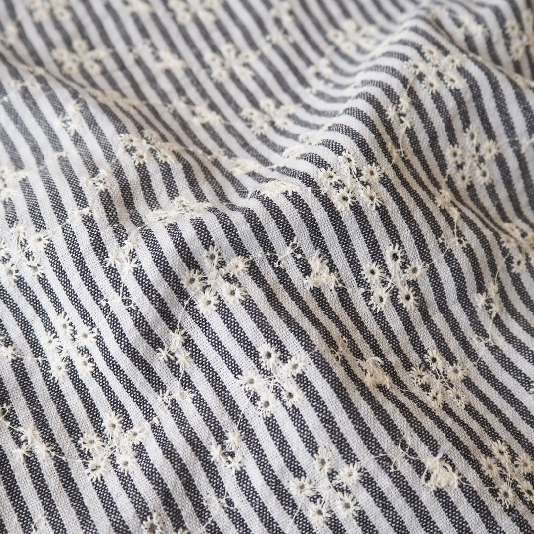 Cotton dressmaking fabric with grey and white design and floral embroidery