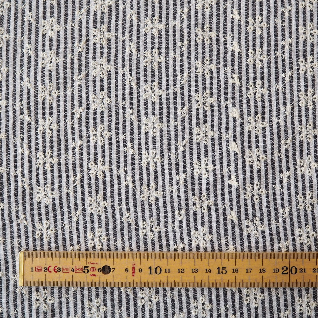 Cotton dressmaking fabric with grey and white design and floral embroidery