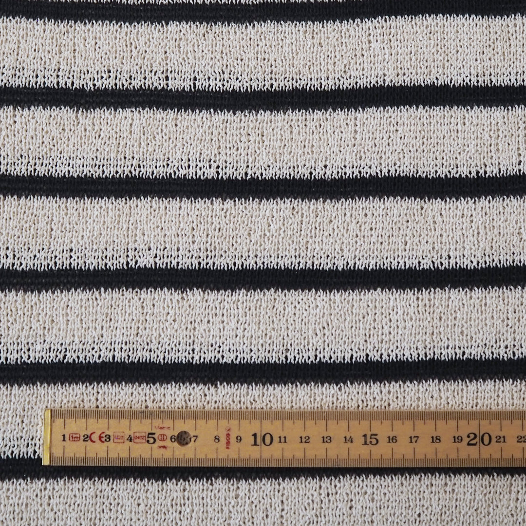 Loose knitted dressmaking fabric with navy and ecru stripes