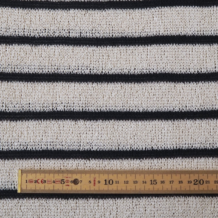 Loose knitted dressmaking fabric with navy and ecru stripes