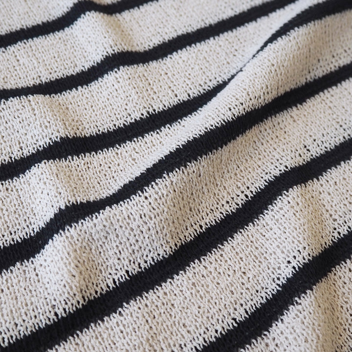 Loose knitted dressmaking fabric with navy and ecru stripes