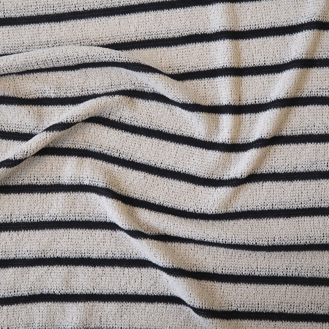 Loose knitted dressmaking fabric with navy and ecru stripes