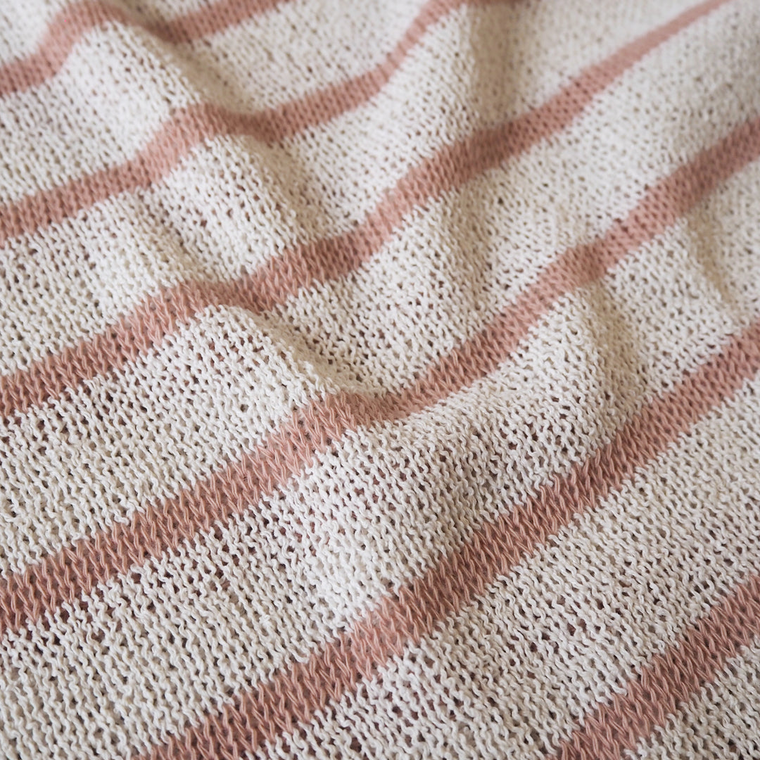 Loose knitted dressmaking fabric with rose pink and ecru stripes