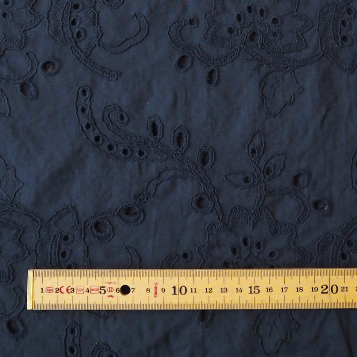 Navy blue embroidered cotton dressmaking fabric with floral pattern