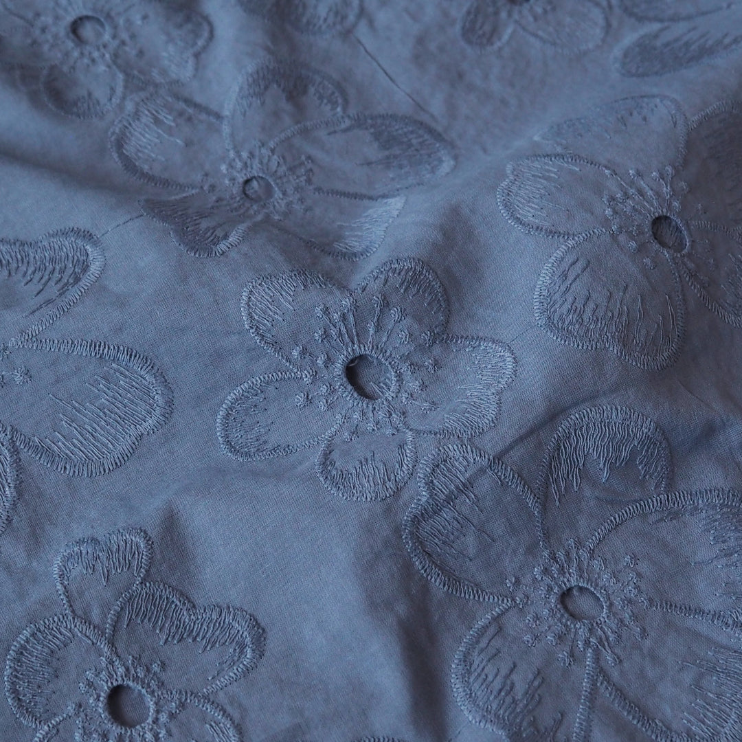 Cornflower blue embroidered cotton dressmaking fabric with floral pattern