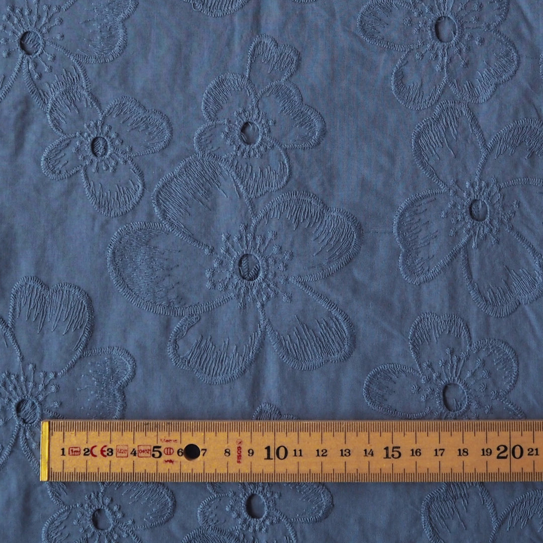 Cornflower blue embroidered cotton dressmaking fabric with floral pattern