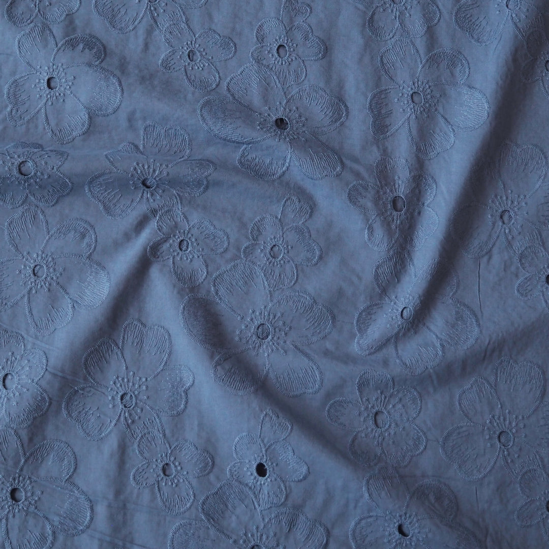 Cornflower blue embroidered cotton dressmaking fabric with floral pattern
