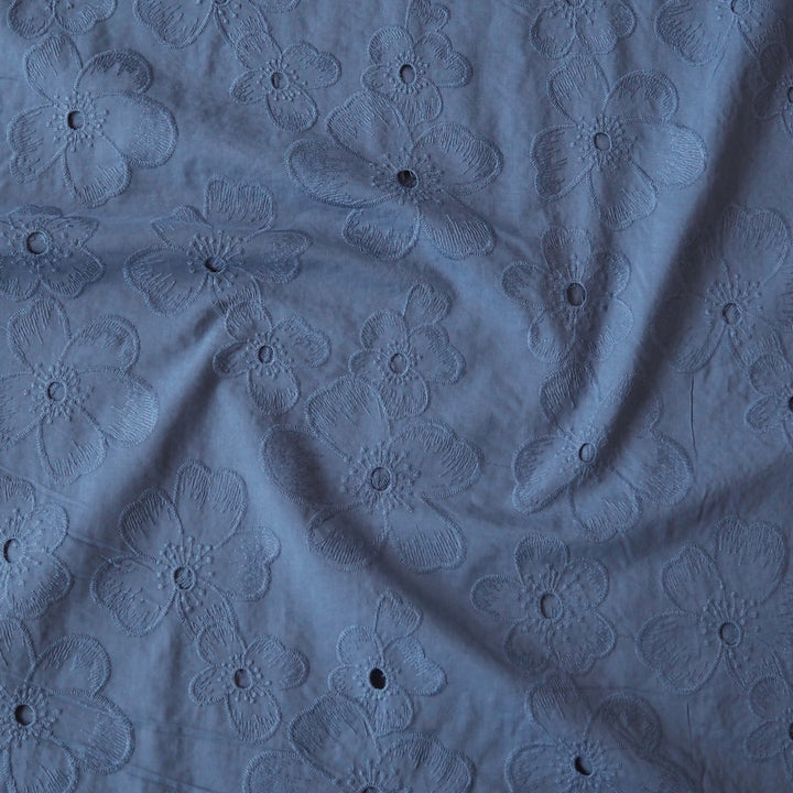 Cornflower blue embroidered cotton dressmaking fabric with floral pattern