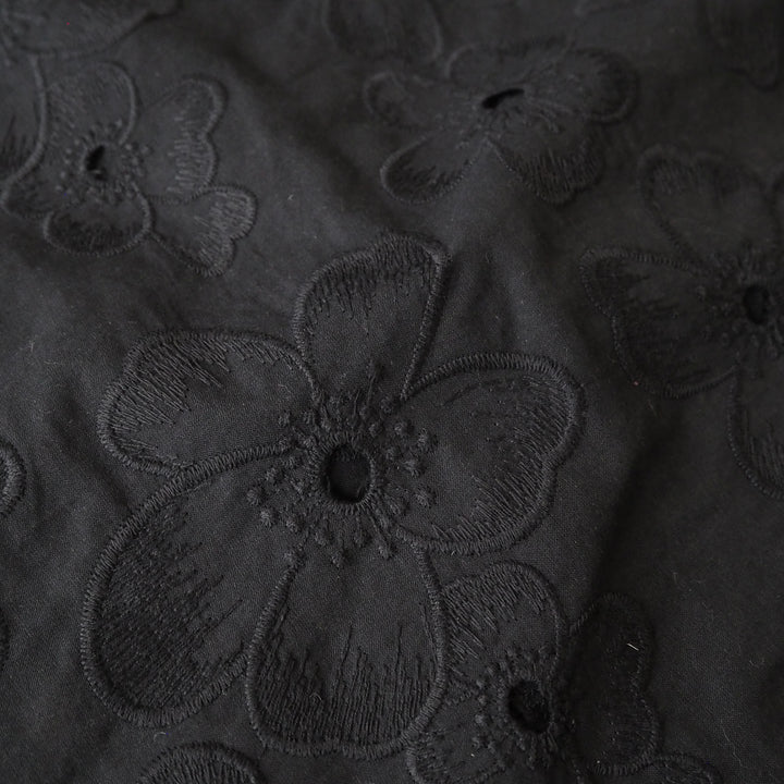 Black embroidered cotton dressmaking fabric with floral pattern