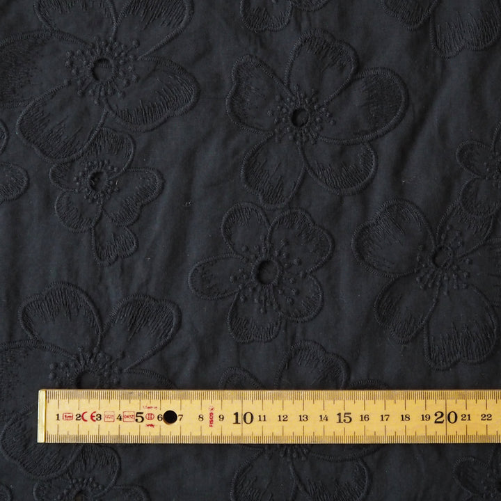 Black embroidered cotton dressmaking fabric with floral pattern
