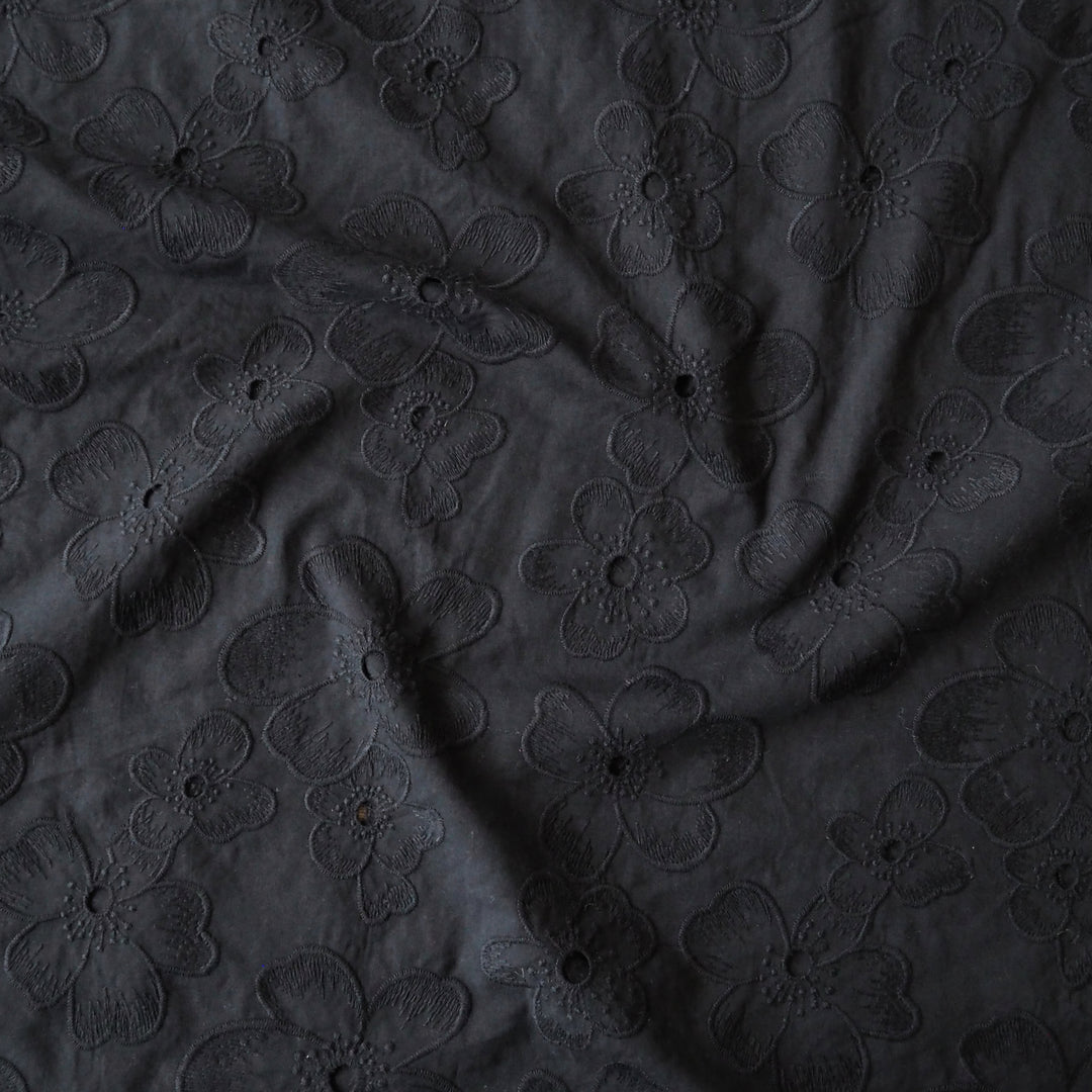 Black embroidered cotton dressmaking fabric with floral pattern